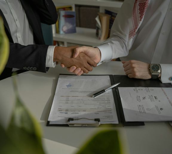 Handshake at a meeting table